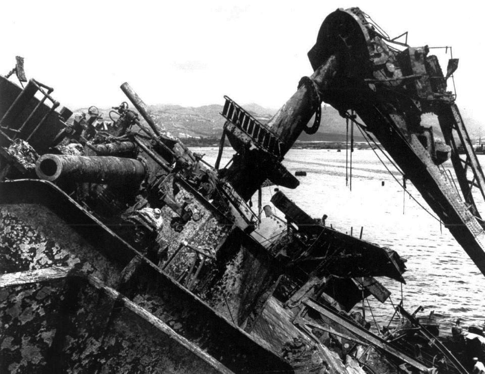 FILE - In this May 24, 1943 file photo, the capsized battleship USS Oklahoma is lifted out of the water at Pearl Harbor in Honolulu, Hawaii. Pearl Harbor survivors and World War II veterans are gathering in Hawaii this week to remember those killed in the Dec. 7, 1941 attack. Those attending will observe a moment of silence at 7:55 a.m., the minute the bombing began. The ceremony will mark the 80th anniversary of the attack that launched the U.S. into World War II. (AP Photo, File)