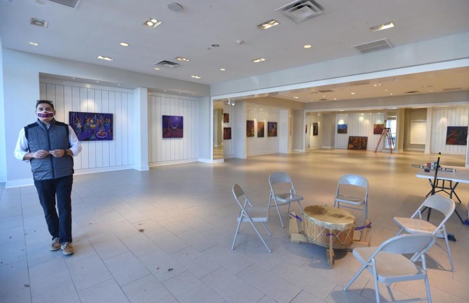 Steven Peters, a spokesman for the Mashpee Wampanoag Tribe, stands in a gallery opened for Native American Heritage Month. The Wampanoag Trading Post and Gallery is featuring an exhibit of artwork and movies by and about the tribe at its Mashpee Commons location and at a vacant storefront across the street.