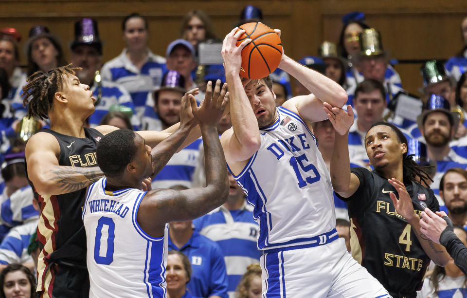 Duke's Ryan Young (15) grabs a rebound ahead over Dariq Whitehead (0), Florida State's Caleb Mills (4), and Cam Corhen (3) during an NCAA college basketball game, Saturday, Dec. 31, 2022, in Durham, N.C. (AP Photo/Ben McKeown)