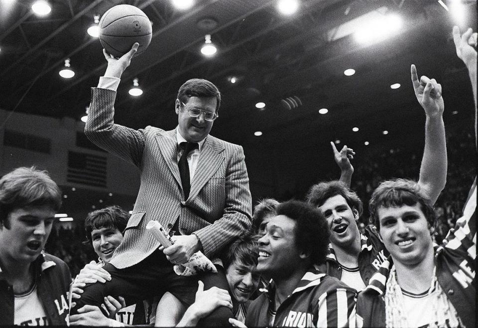 University of Kentucky basketball coach Joe B. Hall was carried off the floor after UK defeated IU 92-90 in the NCAA Mideast Regional finals in Dayton, Ohio, on March 22, 1975. UK players, from left were: Danny Hall, Rick Robey, Jimmy Dan Conner, Marion Haskins, Mike Phillips and Mike Flynn. “That game with Indiana was the most satisfying game, and I think the most important game in my career,” Hall later said.