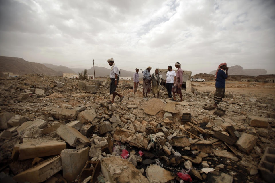 Tribesmen stand on the rubble of a building destroyed by a U.S. drone air strike