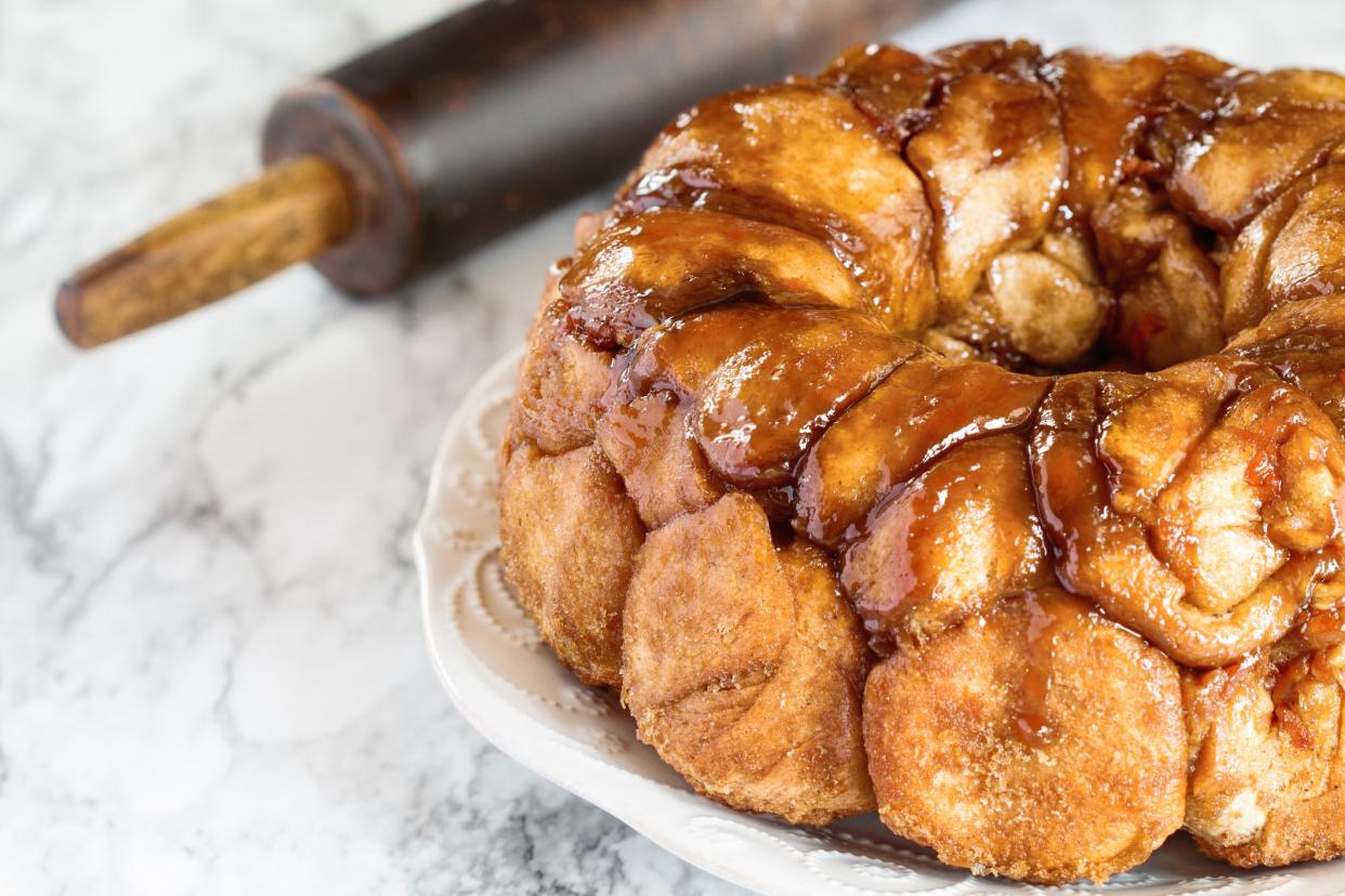 Easter dessert of Pull Apart Carrot Cake Monkey Bread. A yeast bundt cake made with cinnamon, carrots, nuts and a brown sugar glaze. Selective focus with blurred foreground and background.