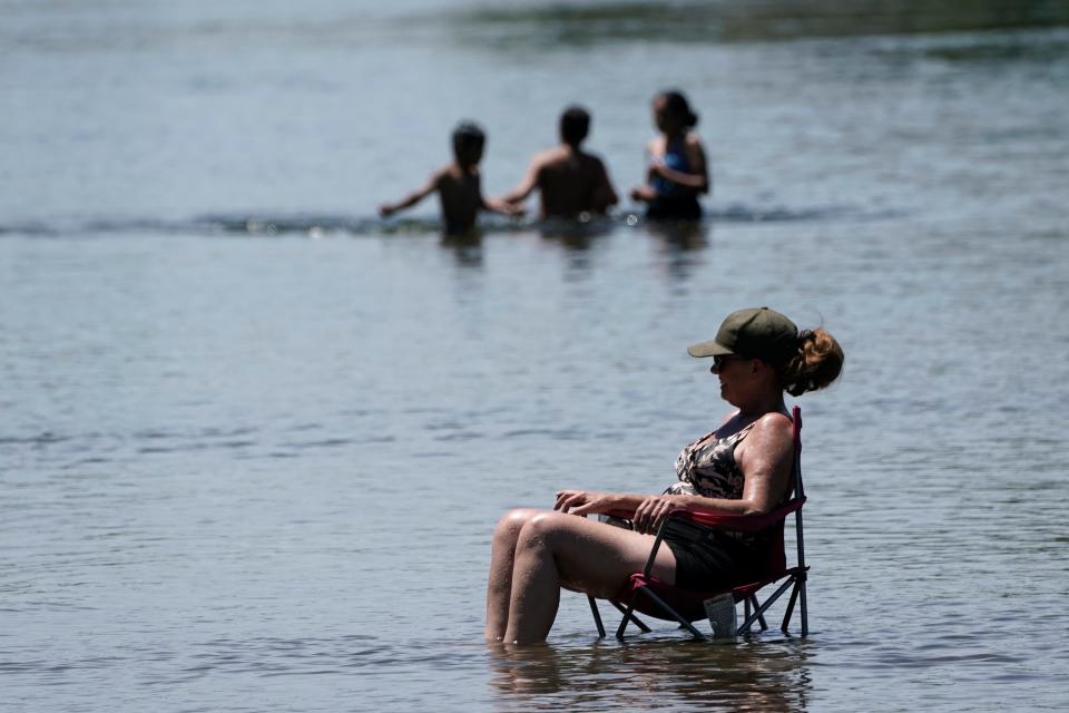 Dianna Andaya relaxes in the American River on Friday in Sacramento, California.