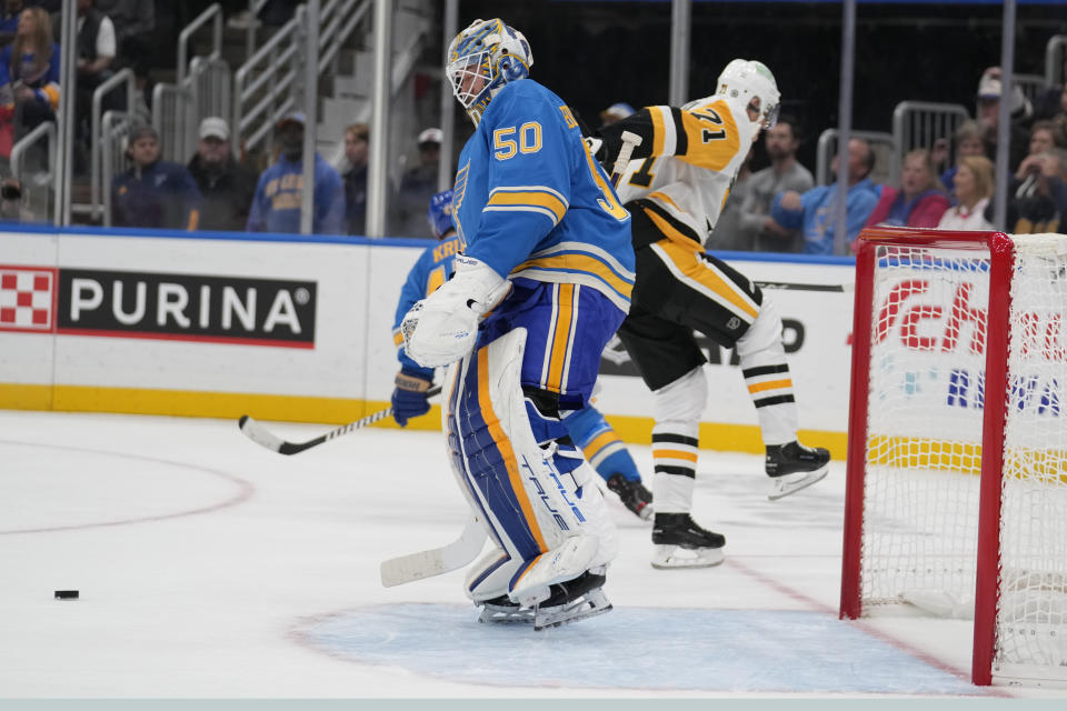 Pittsburgh Penguins' Evgeni Malkin (71) celebrates after scoring past St. Louis Blues goaltender Jordan Binnington (50) during the first period of an NHL hockey game Saturday, Oct. 21, 2023, in St. Louis. (AP Photo/Jeff Roberson)