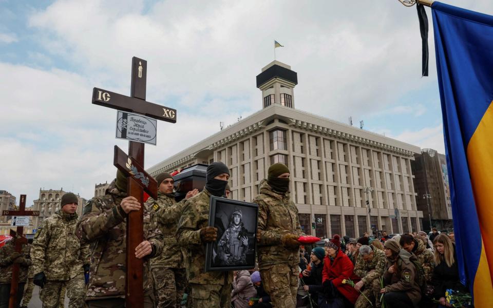 Ukrainian servicemen carry a coffin with the body of a member of the Brotherhood volunteer's battalion, killed during a raid on Russian territory on December 25 - REUTERS/Alina Yarysh