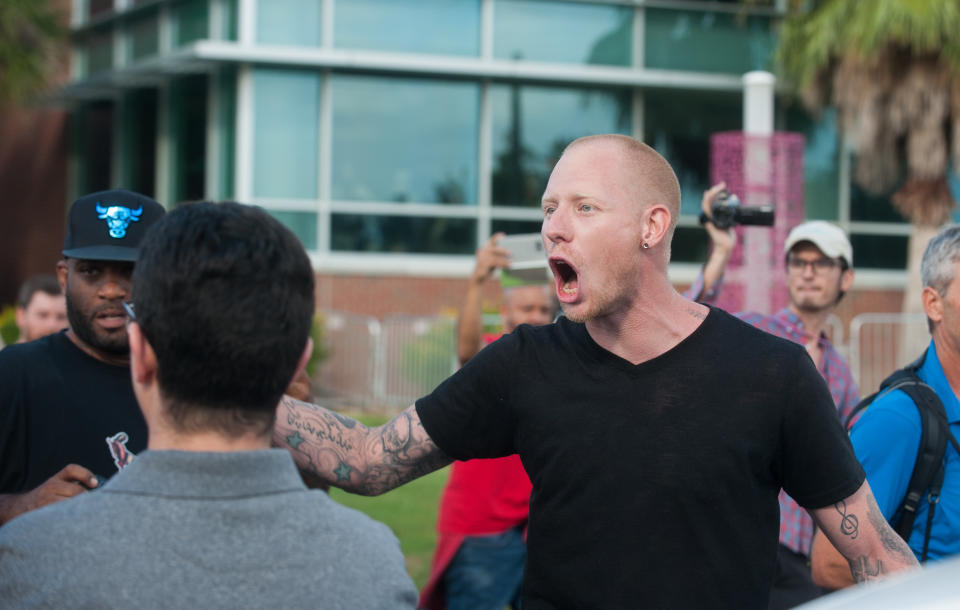 The man argued with protesters before being escorted away by police.&nbsp;