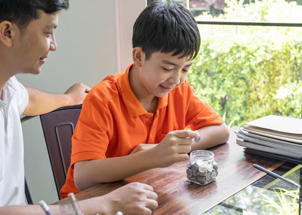 An Asian father teaching his son about investing.