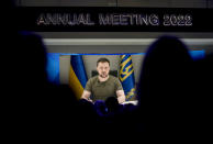 Ukrainian President Volodymyr Zelenskyy displayed on a screen as he addresses the audience from Kyiv on a screen during the World Economic Forum in Davos, Switzerland, Monday, May 23, 2022. The annual meeting of the World Economic Forum is taking place in Davos from May 22 until May 26, 2022. (AP Photo/Markus Schreiber)