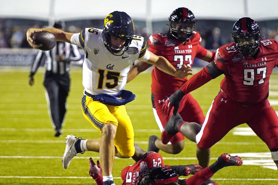 California quarterback Fernando Mendoza (15) skips over Texas Tech defensive back Malik Dunlap (24) for a short gain during the first half of the Independence Bowl NCAA college football game Saturday, Dec. 16, 2023, in Shreveport, La. (AP Photo/Rogelio V. Solis)