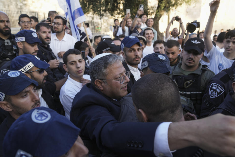 Israel's National Security Minister Itamar Ben-Gvir, center, attends a march marking Jerusalem Day, an Israeli holiday celebrating the capture of east Jerusalem in the 1967 Mideast war, in front of the Damascus Gate of Jerusalem's Old City, Thursday, May 18, 2023. (AP Photo/Mahmoud Illean)