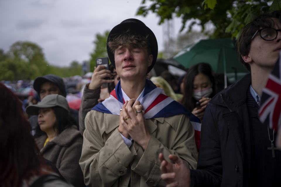 Royal fan Ben Weller reacts as he watches the coronation ceremony of Britain’s King Charles III on a screen in Hyde Park, in London.
