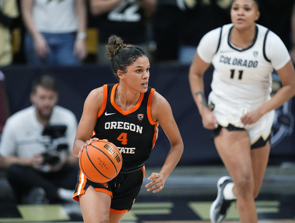 Oregon State guard Donovyn Hunter, left, picks up the ball as Colorado forward Quay Miller, right, pursues in the first half of an NCAA college basketball game Sunday, Feb. 11, 2024, in Boulder, Colo. (AP Photo/David Zalubowski)