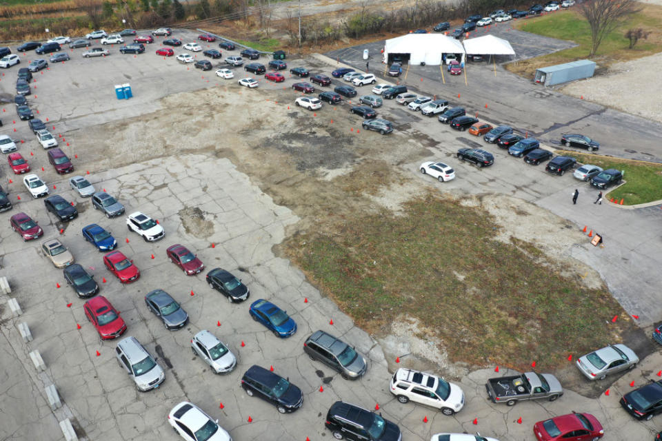 In this drone image, residents in cars wait in line at a drive-up COVID-19 test site in Aurora, Illinois.