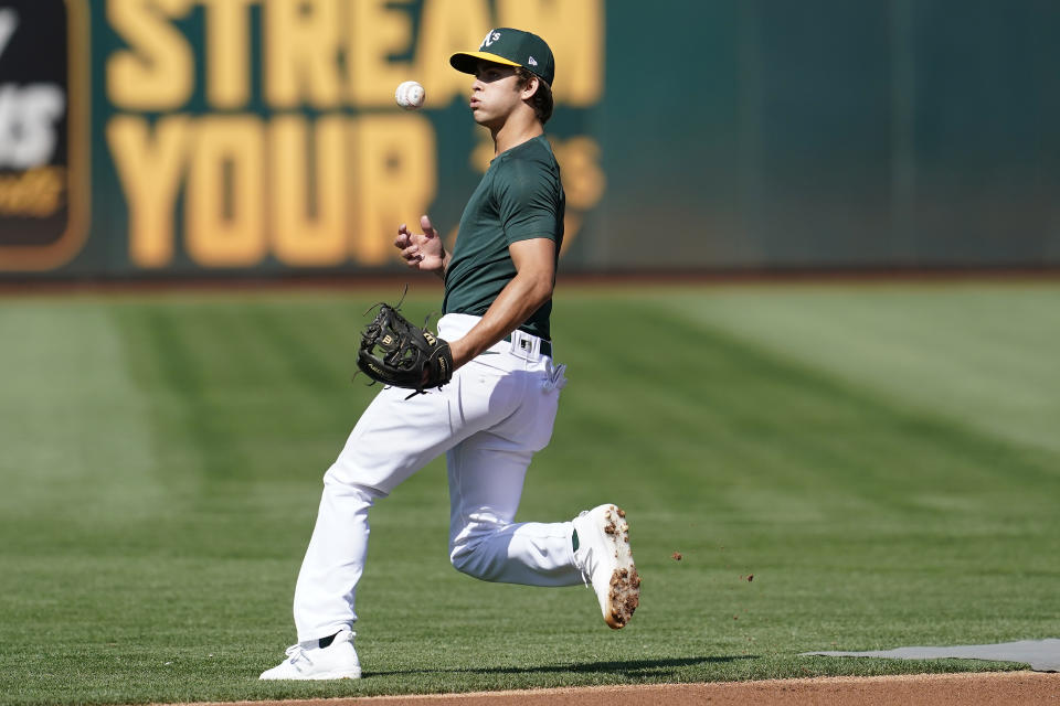 Oakland Athletics draft pick Max Muncy fields a ground ball during batting practice before a baseball game between the Athletics and the Los Angeles Angels in Oakland, Calif., Monday, July 19, 2021. (AP Photo/Jeff Chiu)