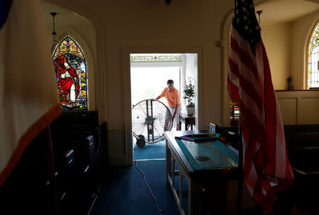 Woody Strickland adjusts a ventilation fan in the sanctuary of Fair Bluff Baptist Church after flooding due to Hurricane Florence receded in Fair Bluff, North Carolina, U.S. September 29, 2018. REUTERS/Randall Hill