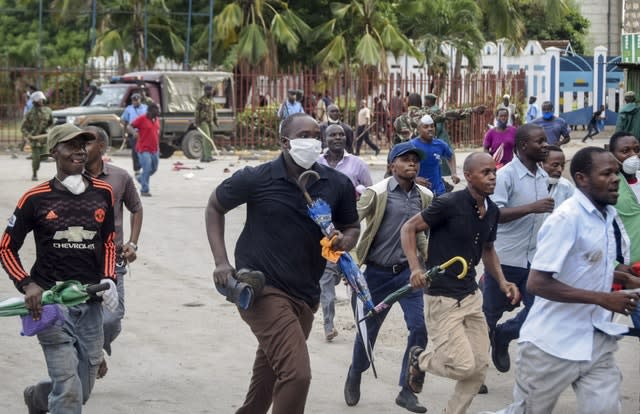 Ferry passengers flee from police firing tear gas in Mombasa, Kenya