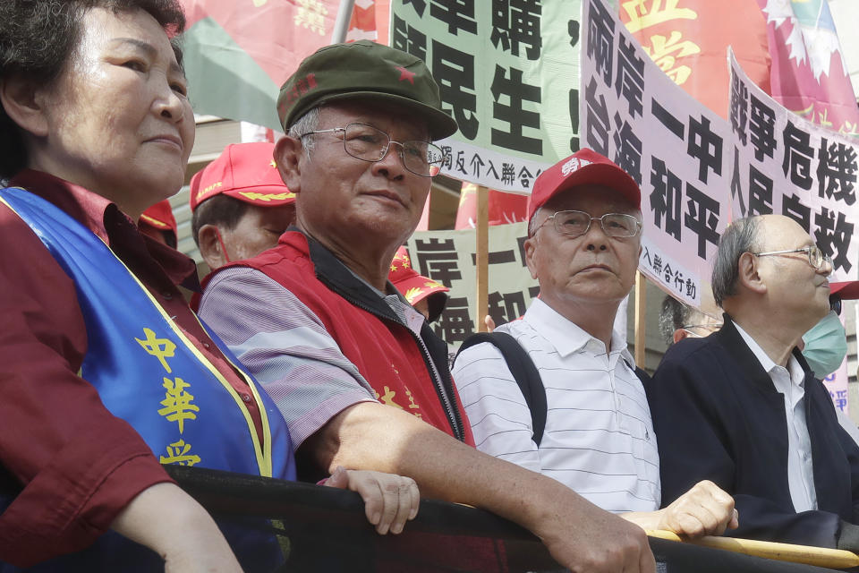 Chairman of Taiwan People's Communist Party Lin Te-wang, second from left, attends a protest outside of the Taipei International Convention Center during the Taiwan-U.S. Defense Industry Forum in Taipei, Taiwan on May 3, 2023. Prosecutors in Taiwan have indicted Lin and the party's Vice Chairman Chen Chien-hsin on accusations they colluded with China in an effort to influence next year’s elections for president and members of the legislative assembly. (AP Photo/Chiang Ying-ying)