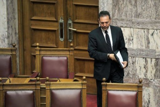 Greece's new Finance Minister Yiannis Sturnaras arrives at the Greek parliament in Athens. Greek Prime Minister Antonis Samaras on Friday asked EU-IMF creditors for more time for a tough bailout programme, to ease the pain on an economy struggling in its fifth year of recession