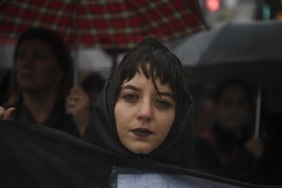 A woman protests in all black in Buenos Aires.&nbsp;
