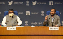 India's Information Technology Minister Ravi Shankar Prasad, left and Information and Broadcasting Minister Prakash Javadekar address a press conference in New Delhi, India, Thursday, Feb. 25, 2021. India on Thursday rolled out new regulations for social media companies and digital streaming websites to make them more accountable for the online content shared on their platforms, giving the government more power to police it. (AP Photo/Manish Swarup)