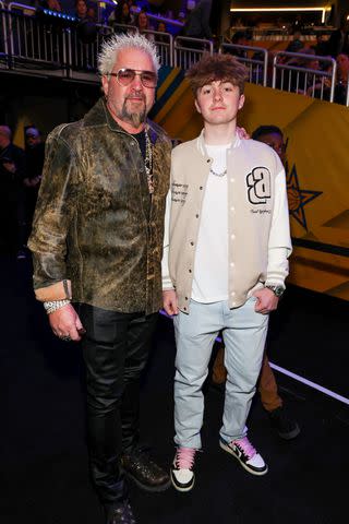 <p>Kevin Mazur/Getty</p> Guy Fieri with son Ryder at the NBA All-Star Game in February.