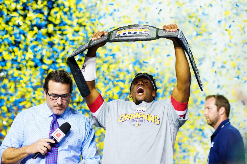 Dec 4, 2021; Lafayette, LA, USA; Louisiana Ragin' Cajuns quarterback Levi Lewis (right) celebrates after being named the MVP of the Sun Belt Conference championship game after defeating the Appalachian State Mountaineers. Mandatory Credit: Andrew Wevers-USA TODAY Sports