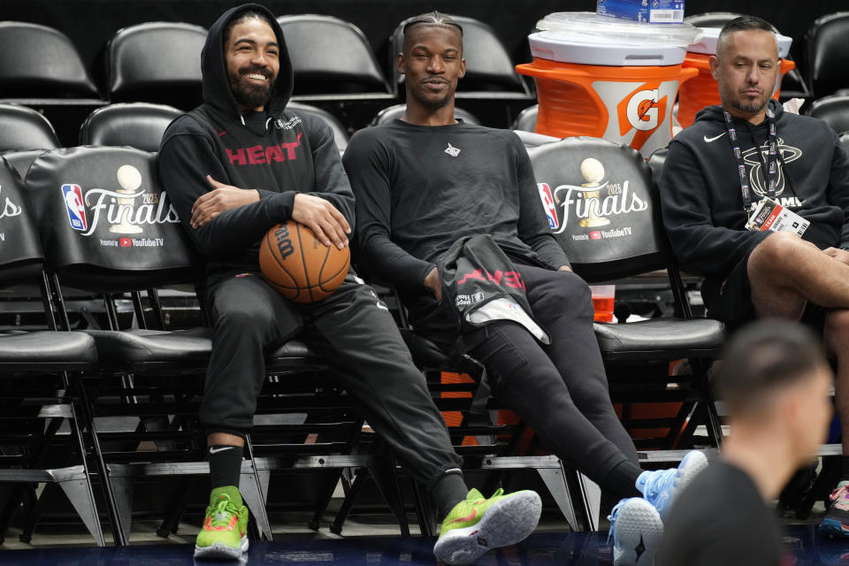 Miami Heat guard Gabe Vincent, left, and forward Jimmy Butler look on from the bench during practice for Game 2 of the NBA Finals, Saturday, June 3, 2023, in Denver. (AP Photo/David Zalubowski)