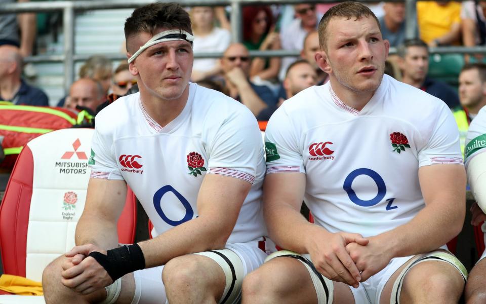 Tom Curry (L) and Sam Underhill of England look on from the replacement bench during the Quilter International match between England and Ireland at Twickenham Stadium on - Getty Images