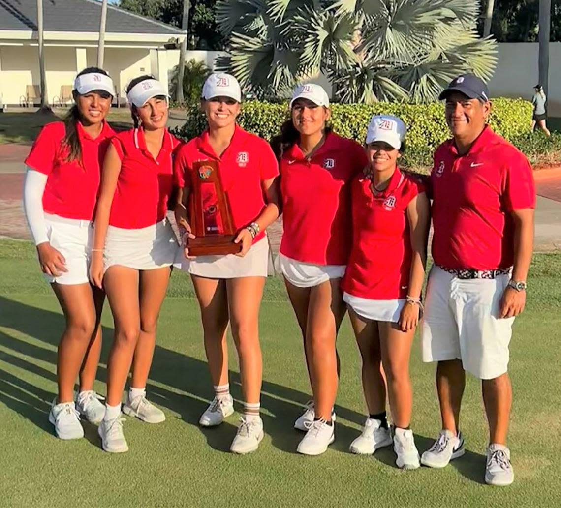 (From left) Isabella Russo, Manuela Suarez, Gabriella Gomez, Maria Quintero Mia Caraballo and Doral Academy Coach Armando Echeverria after winning the Region 4-3A girls’ golf title at the Boca Golf and Racquet Club.