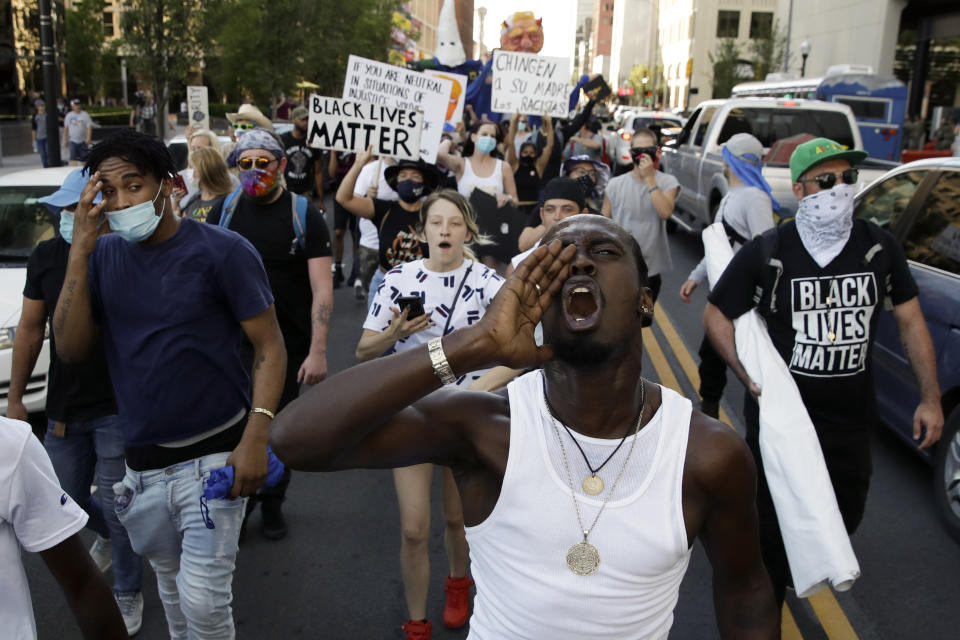 FILE - In this June 20, 2020, file photo, demonstrators march near the BOK Center in Tulsa, Okla. Proposed federal legislation that would radically transform the nation's criminal justice system through such changes as eliminating agencies like the Drug Enforcement Administration and the use of federal surveillance technology is set to be unveiled Tuesday, July 7, by the Movement for Black Lives. (AP Photo/Charlie Riedel, File)