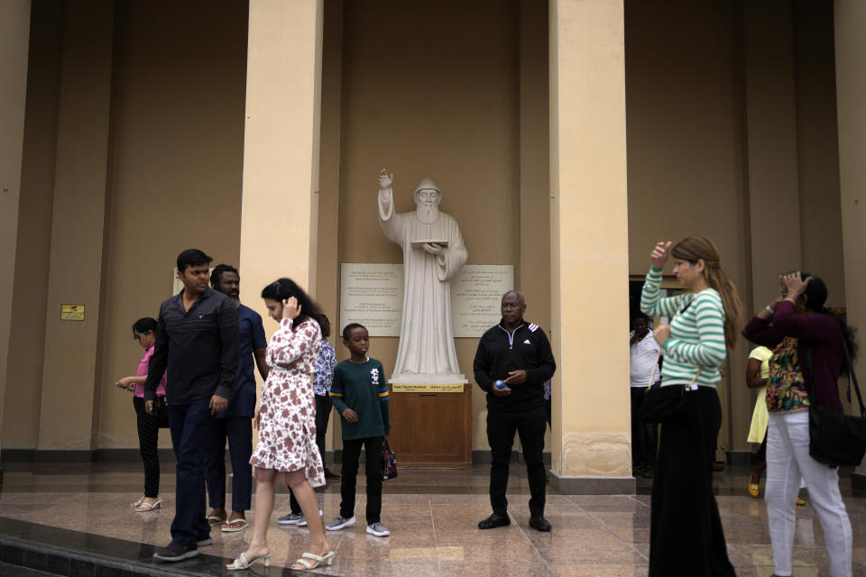 People stand outside the Catholic Church, Our Lady of the Rosary, at the Religious complex, in Doha, Qatar, Friday, Dec. 9, 2022. (AP Photo/Thanassis Stavrakis)