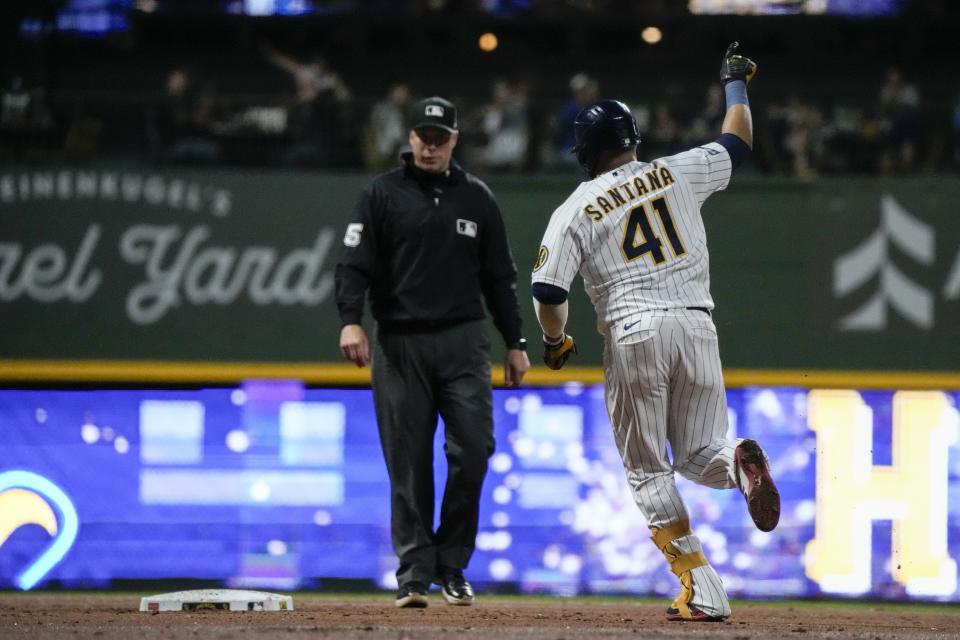 Milwaukee Brewers' Carlos Santana reacts after hitting a home run during the second inning of a baseball game against the Chicago Cubs Saturday, Sept. 30, 2023, in Milwaukee. (AP Photo/Morry Gash)