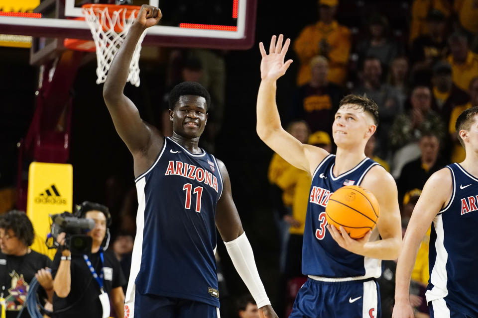 Arizona's Oumar Ballo (11) and Belle Larsson (3) celebrate after their win over Arizona State in an NCAA college basketball game, Saturday, Dec. 31, 2022, in Tempe, Ariz. (AP Photo/Darryl Webb)
