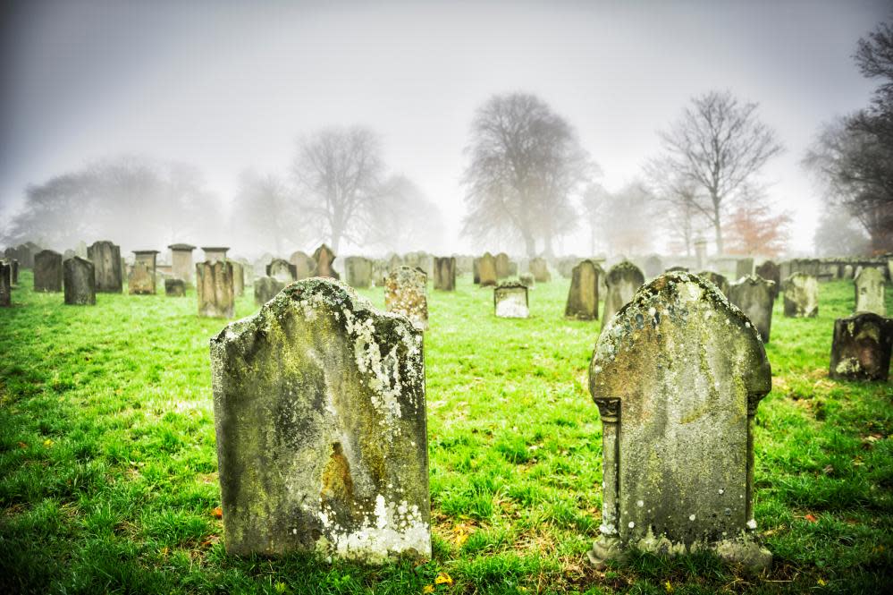 Close-up of dilapidated gravestones in cemetery