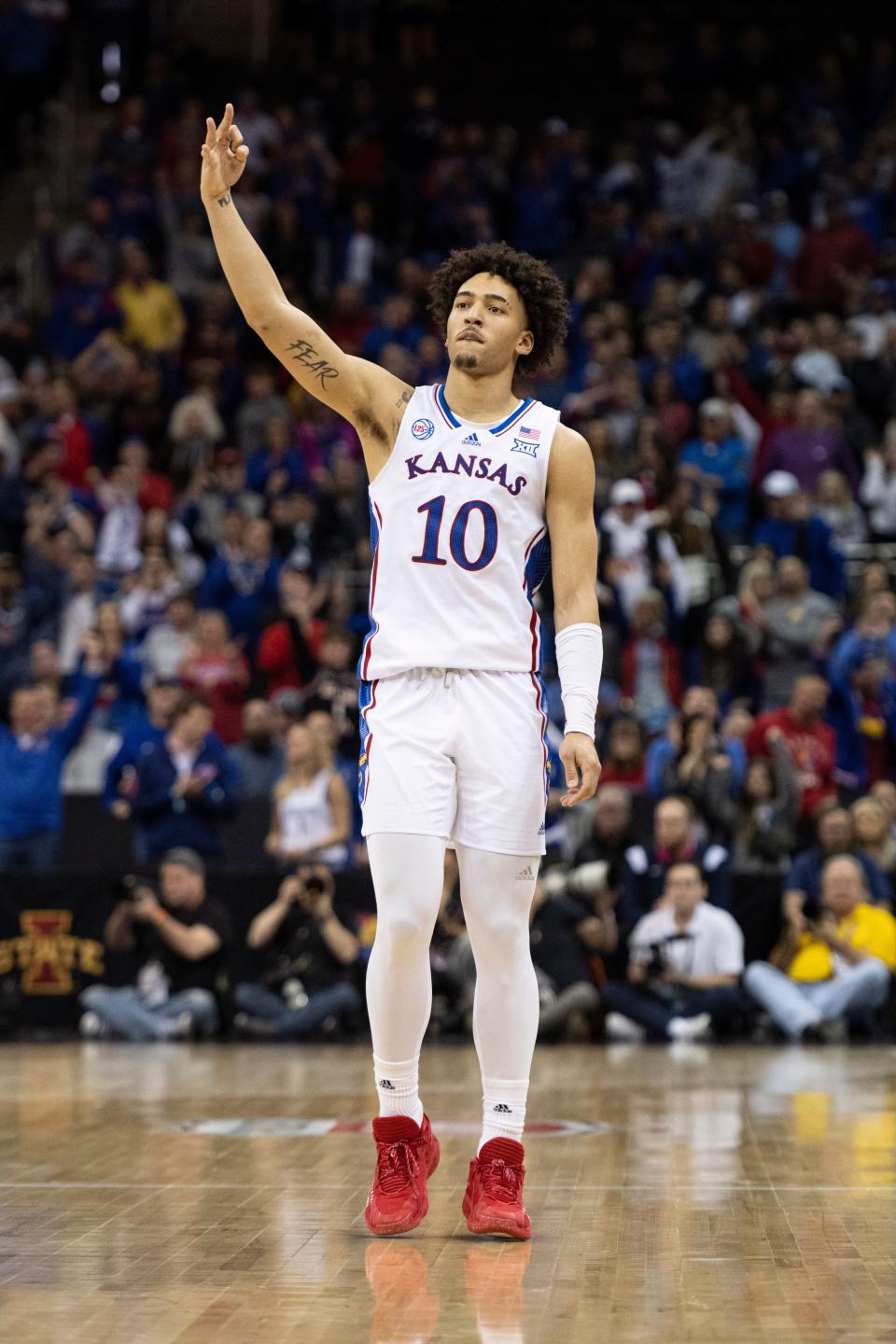 Kansas forward Jalen Wilson (10) celebrates a made three-point attempt against West Virginia during the Big 12 Conference tournament at the T-Mobile Center in Kansas City.