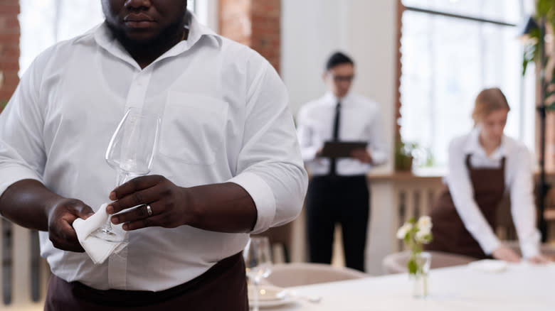 Bussers cleaning up restaurant tables