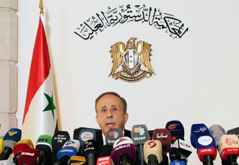 Head of the higher constitutional court, Jihad Al Laham, speaks during a news conference in Damascus