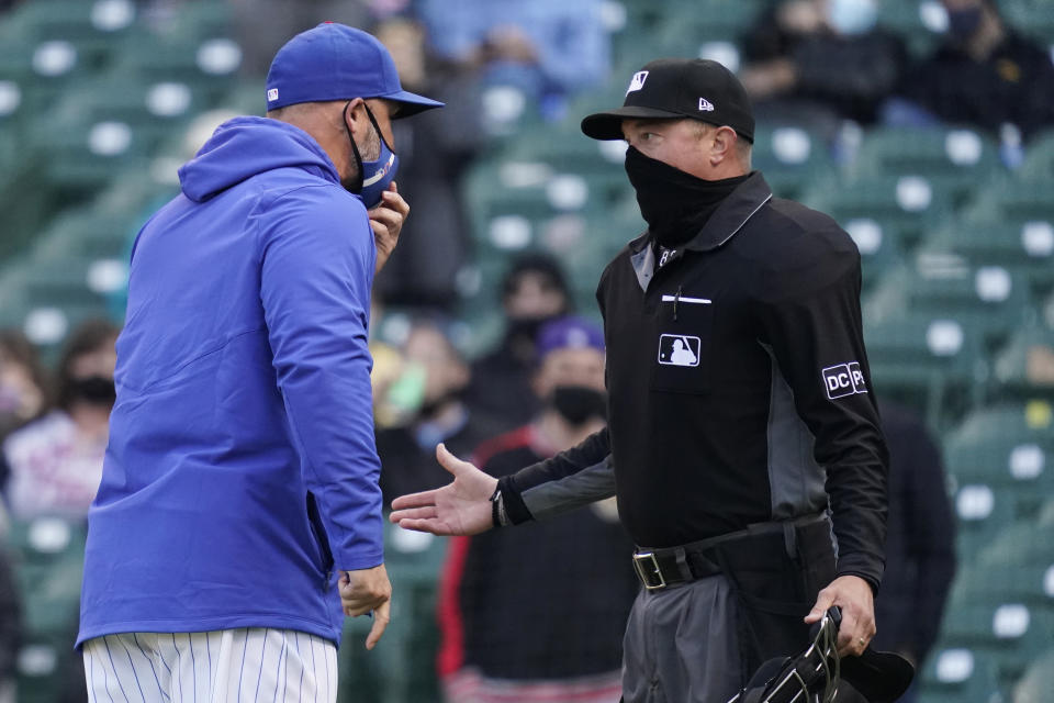 Chicago Cubs manager David Ross, left, argues with umpire Cory Blaser during the ninth inning of a baseball game against the Milwaukee Brewers in Chicago, Saturday, April 24, 2021. (AP Photo/Nam Y. Huh)