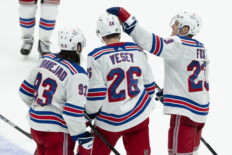 New York Rangers left wing Jimmy Vesey (26) celebrates after his empty-net goal with center Mika Zibanejad (93) and defenseman Adam Fox (23) during the third period of an NHL hockey game against the Anaheim Ducks, Sunday, Jan. 21, 2024, in Anaheim, Calif. (AP Photo/Kyusung Gong)