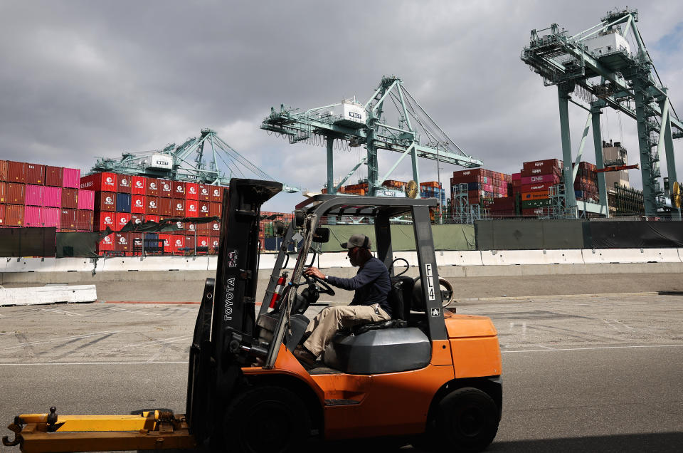 LOS ANGELES, CALIFORNIA - SEPTEMBER 20: A worker drives a forklift near shipping containers stacked at the Port of Los Angeles on September 20, 2024 in Los Angeles, California. The Port of Los Angeles has seen a 17 percent surge in cargo traffic for the first eight months of the year compared to its 2023 pace amid a looming ports strike. (Photo by Mario Tama/Getty Images)