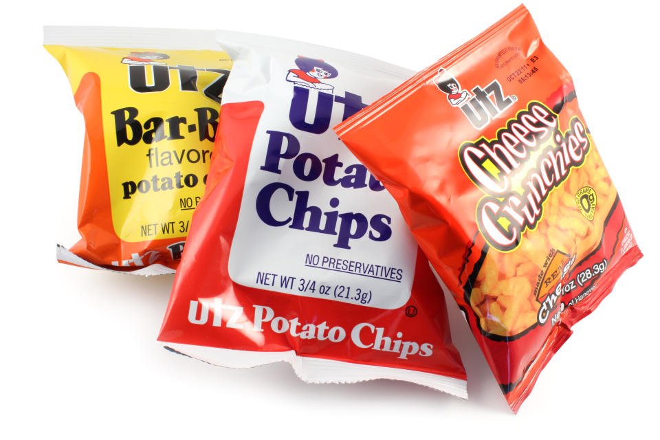 Quakertown, Pennsylvania, United States - September 07, 2011. Utz snacks isolated on a white background. Cheese crunchies, bar-b-q potato chips and plain potato chips.