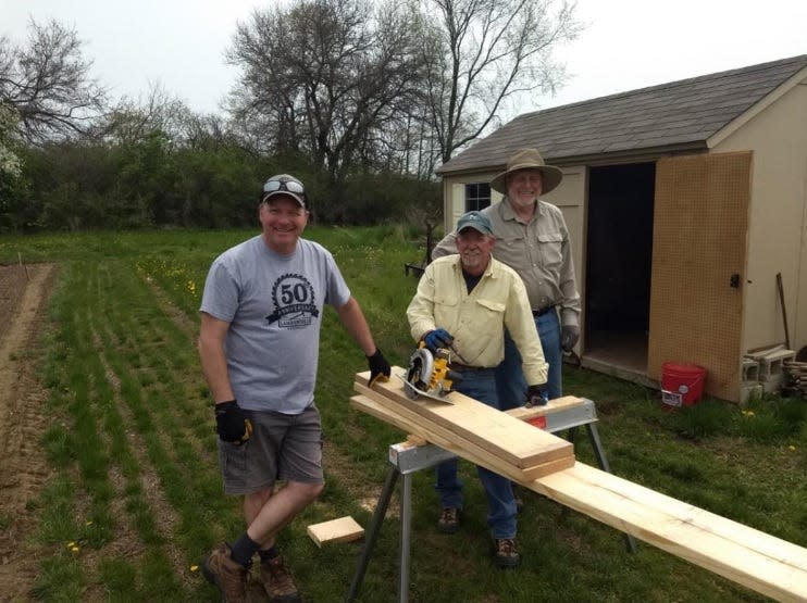 Andy McCain, Pete Loughney and Don Zimmerman work to build some raised beds at the MCCC Student Ag Farm on Wednesday, May 11.