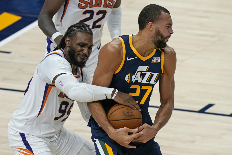 Phoenix Suns forward Jae Crowder (99) tries to get a rebound from Utah Jazz center Rudy Gobert (27) during the second half of an NBA basketball game Thursday, Dec. 31, 2020, in Salt Lake City. (AP Photo/Rick Bowmer)