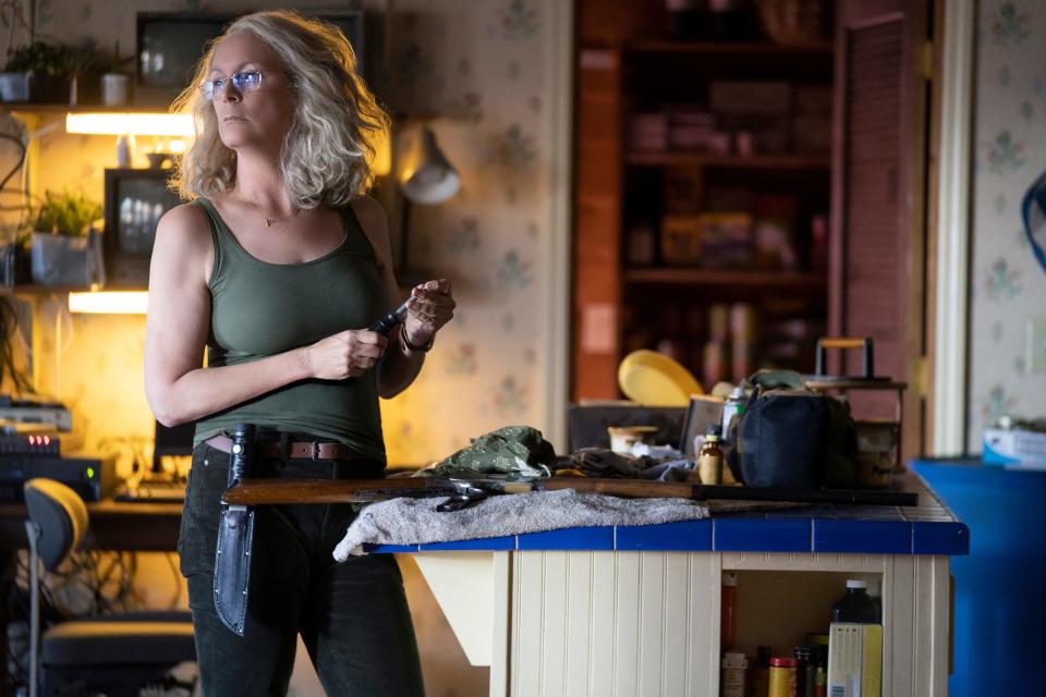 Laurie Strode (Jamie Lee Curtis) gets all her weaponry in order as she waits for the return of masked psycho Michael Myers in 2018's "Halloween."