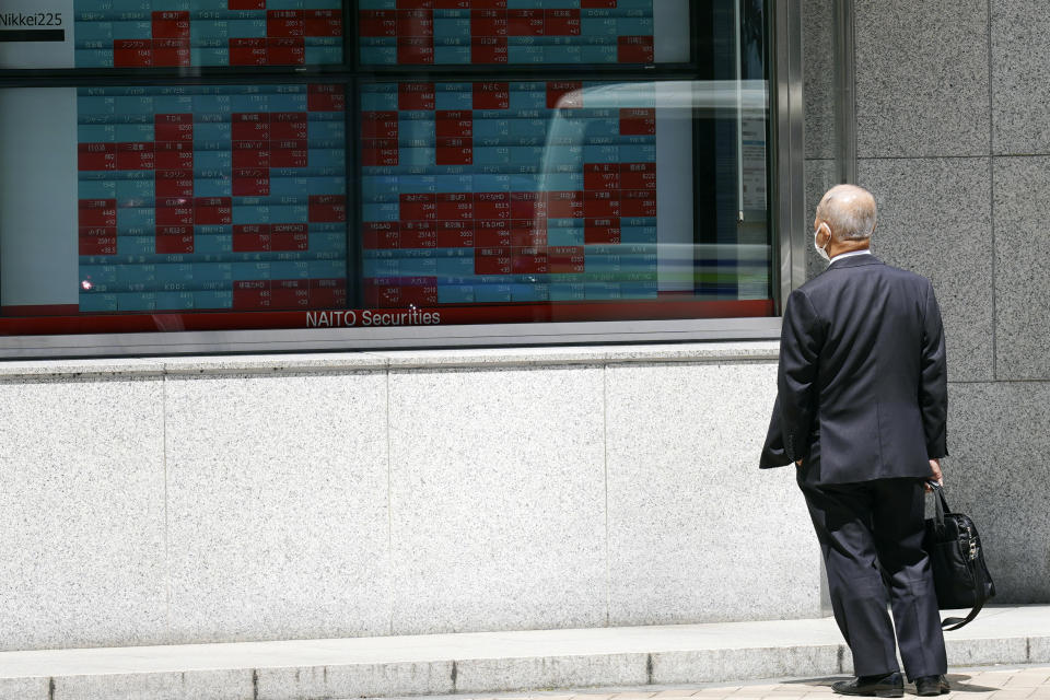 A person looks at an electronic stock board showing Japan's stock prices at a securities firm Wednesday, May 24, 2023, in Tokyo. Asian stock markets slid Wednesday as the U.S. government crept closer to a potentially disruptive default on its debt. (AP Photo/Eugene Hoshiko)