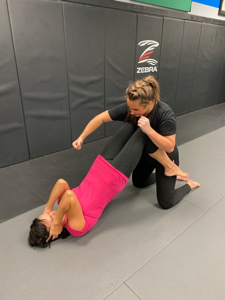 A student at the Warriors Women's Self Defense class in Bartlett learn how to fend off an attacker.