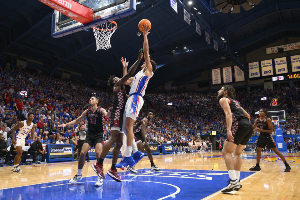 Kansas guard Kevin McCullar Jr., right, goes up for a basket against North Carolina Central guard Keishon Porter, left, during the first half of an NCAA college basketball game in Lawrence, Kan., Monday, Nov. 6, 2023. (AP Photo/Reed Hoffmann)