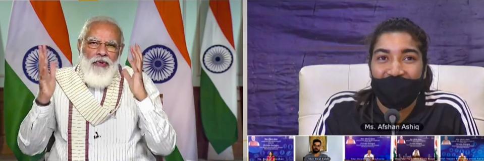 **EDS: SCREENSHOT FROM A VIDEO POSTED BY @narendramodi ON THURSDAY, SEPT. 24, 2020** New Delhi: Prime Minister Narendra Modi virtually interacts with J&K women's football team captain Afshan Ashiq along with other fitness enthusiasts during Fit India Dialogue on the first anniversary of Fit India Movement, in New Delhi. (PTI Photo)(PTI24-09-2020_000031A)