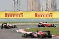 Formula One - Chinese F1 Grand Prix - Shanghai, China - 17/4/16 - Ferrari Formula One driver Kimi Raikkonen of Finland (R) drives during the Chinese Grand Prix. REUTERS/Aly Song