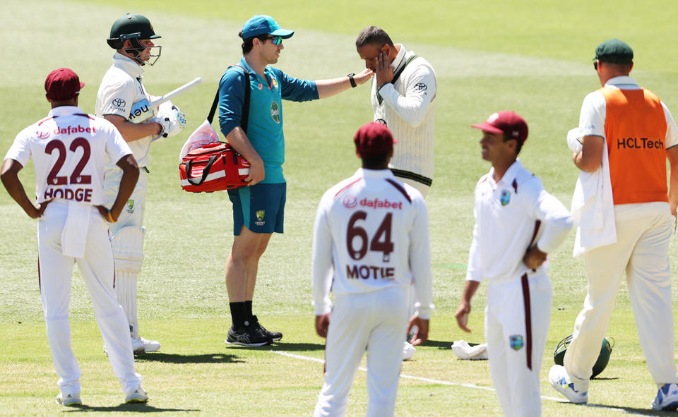 Medical staff, pictured here checking on Usman Khawaja after he was hit on the jaw. 